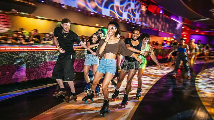 Xanadu roller rink with skaters front and center