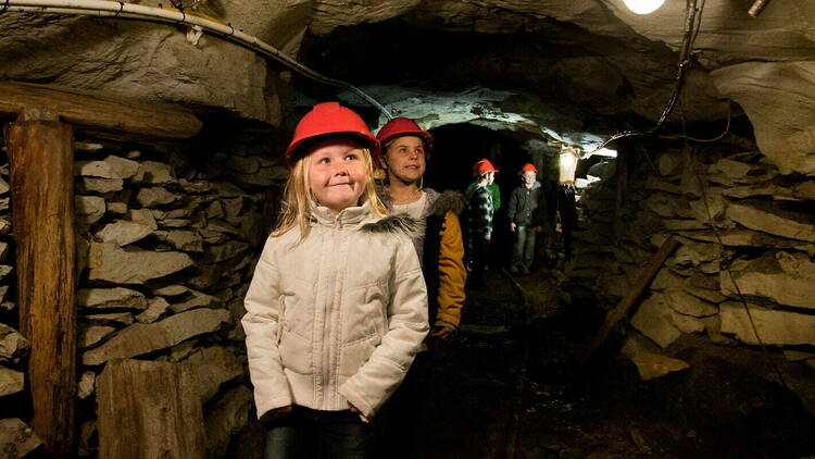 Children walking through an underground tunnel. 