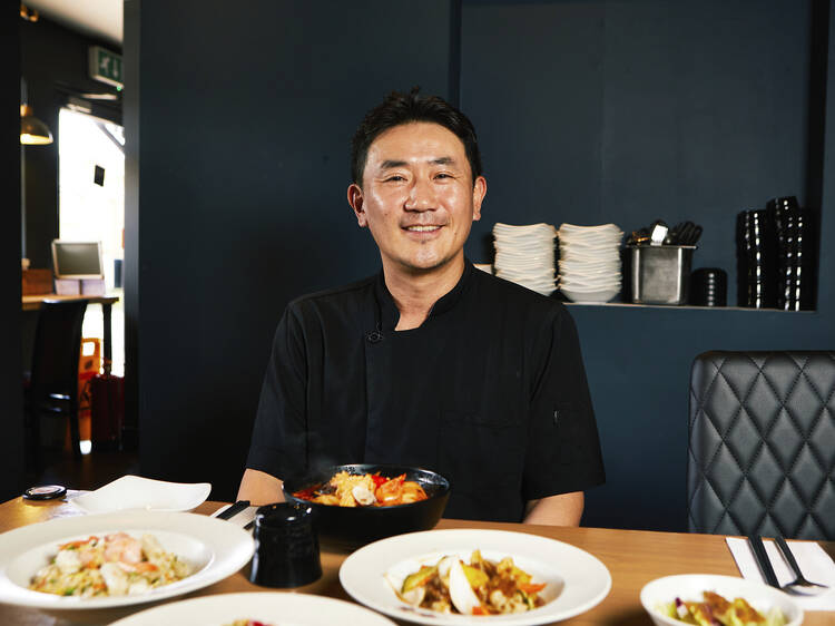 A man sitting at a table of food 