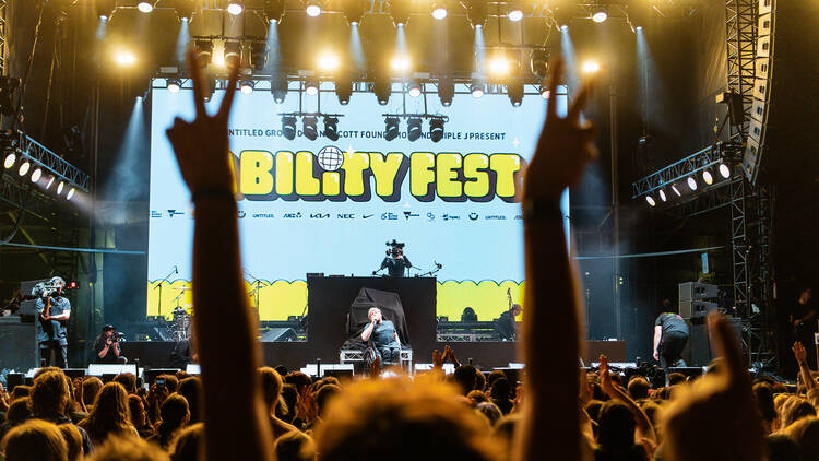 Dylan Alcott on stage in front of a huge crowd at Ability Fest.