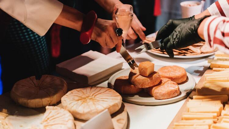 A table filled with wheels of cheese. 