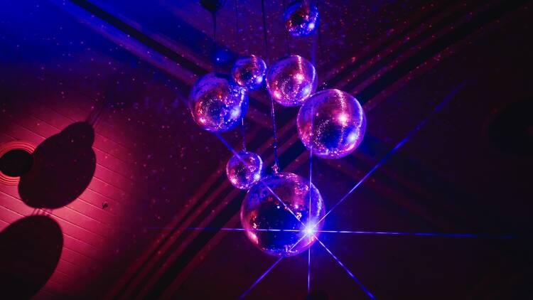 Several sparkling disco balls hanging from the ceiling. 