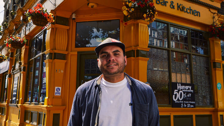 A man standing outside a restaurant 