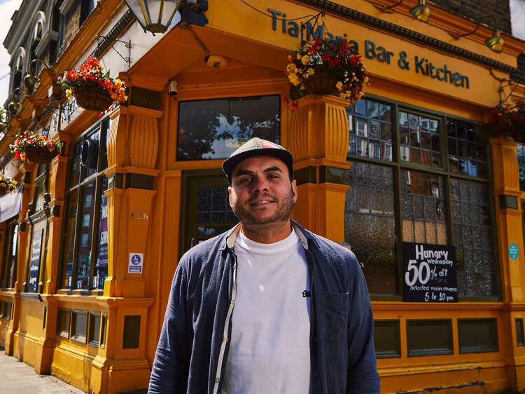 A man standing outside a restaurant 