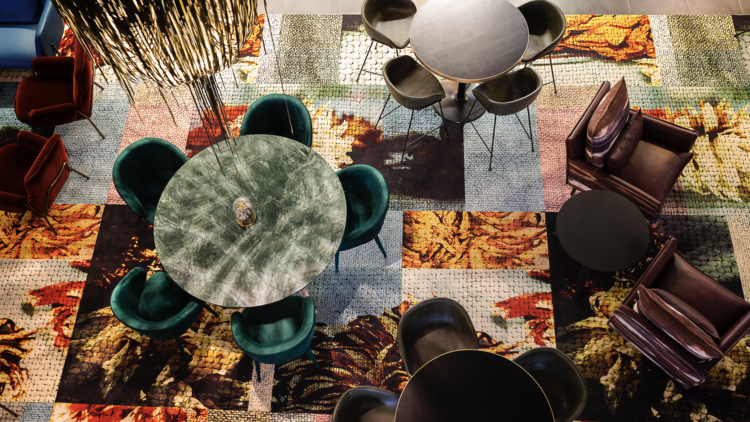 East Hotel aerial view of lobby with colourful rug and seating