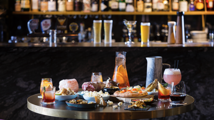 Spread of cocktails and bar snacks