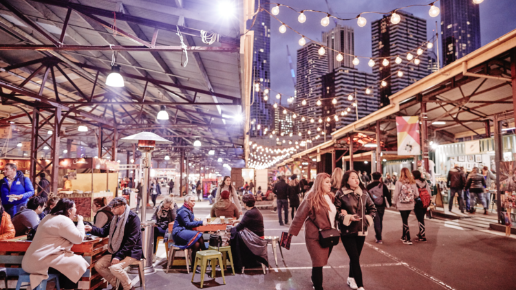 People walk around the Queen Victoria Night Markets