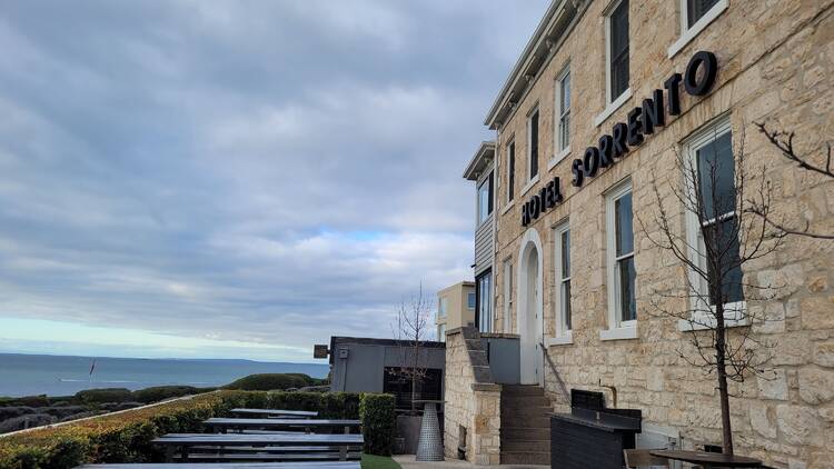 An old heritage stone building looking out over a bay.