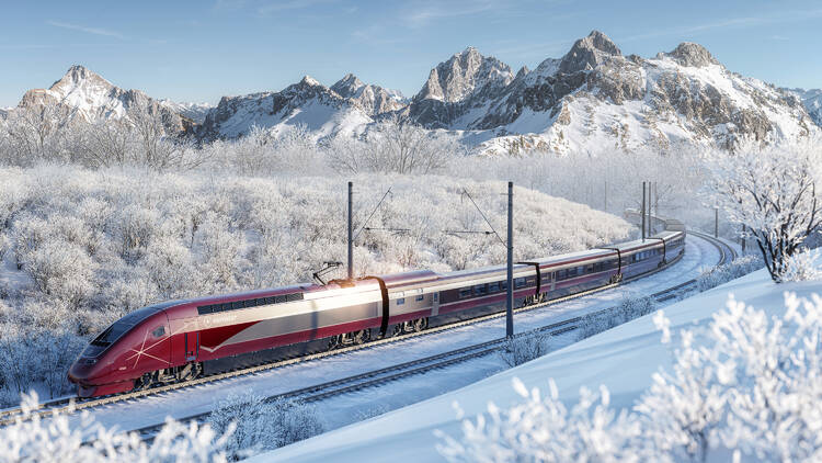 Eurostar train driving through snowy mountains 