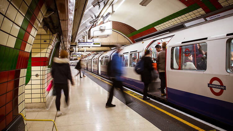 An image of people stepping on board a Bakerloo line carriage. 