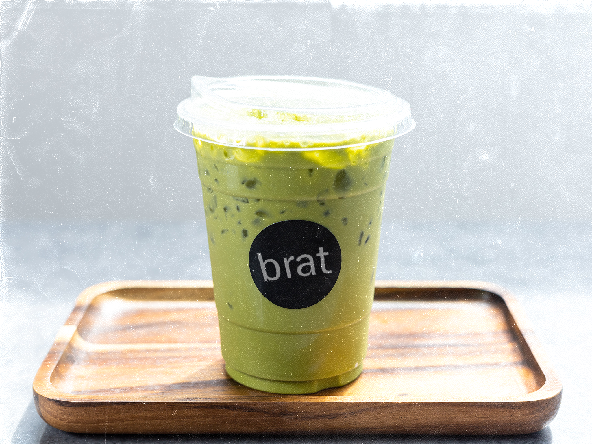 illustration of green iced matcha latte with brat sticker on it