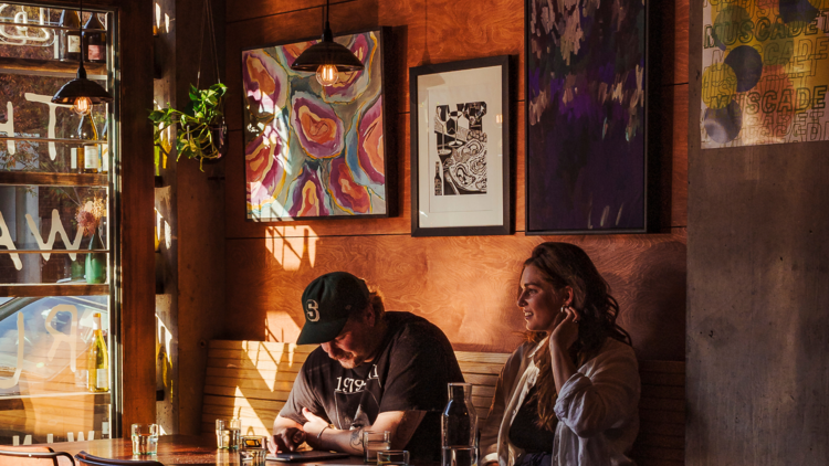 Seated pair enjoying wine at The Walrus.