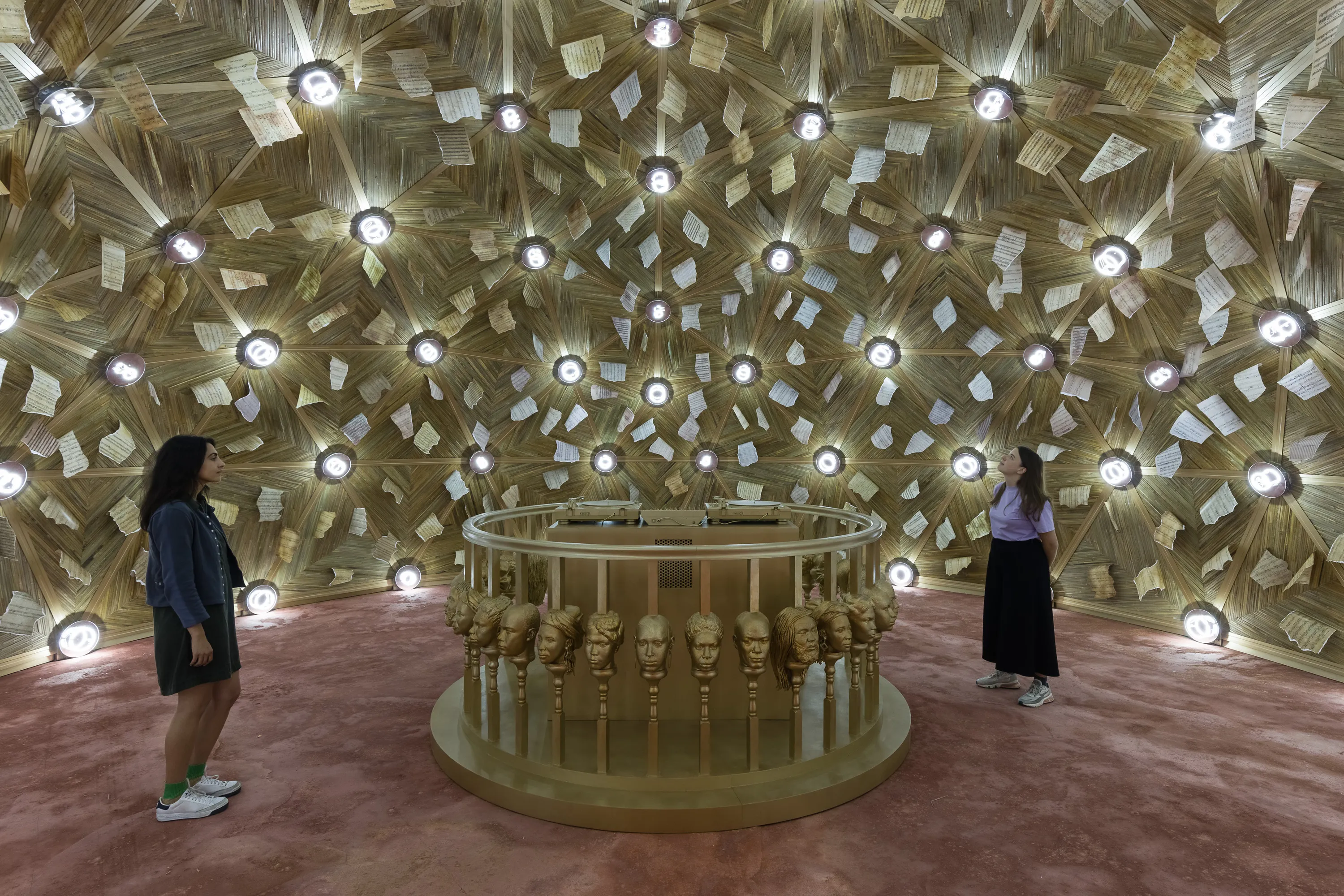 two people stand inside an art installation