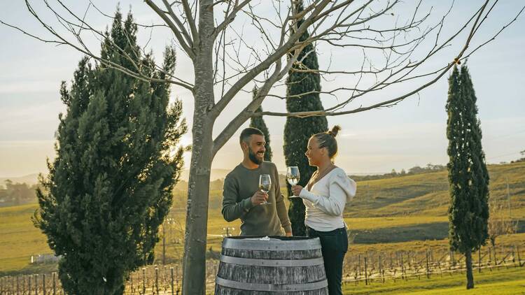 A couple enjoying a wine at Cupitt's Estate