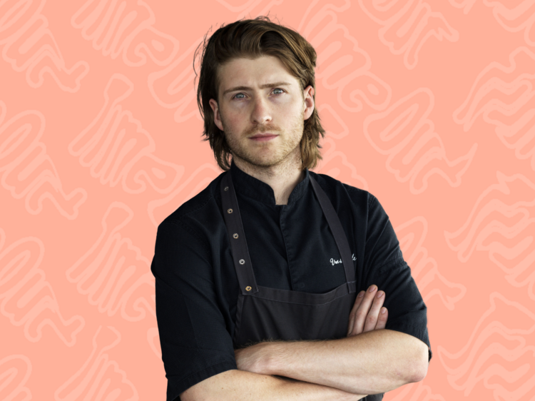 Chef Hugh Allen against a pale pink backdrop.