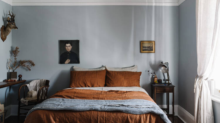 Bedroom with orange doona on double bed