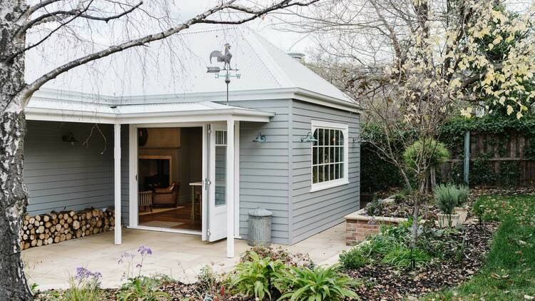 Grey cottage exterior leading to garden