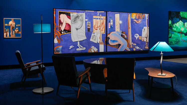 Blue room with three artworks