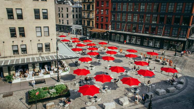 An aerial view of the Meatpacking District with red umbrellas.