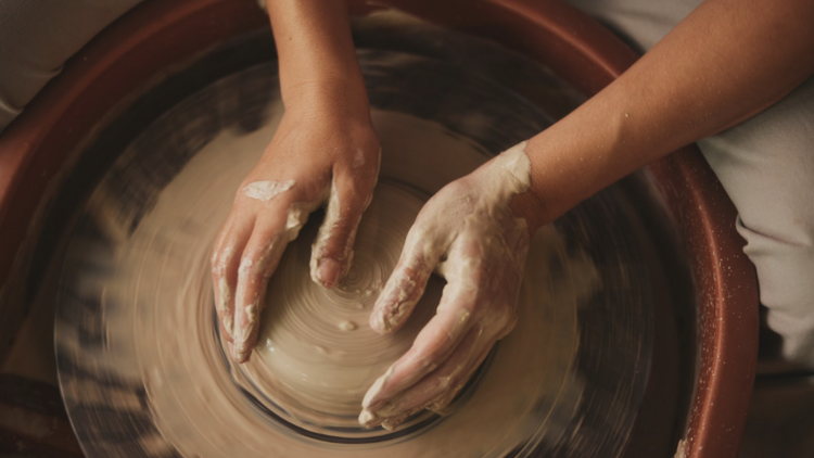 A group pottery wheel throwing party