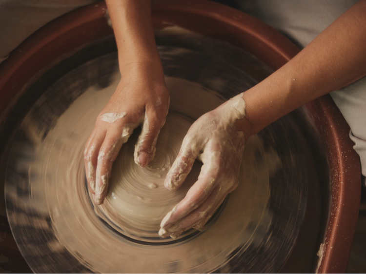 A group pottery wheel throwing party