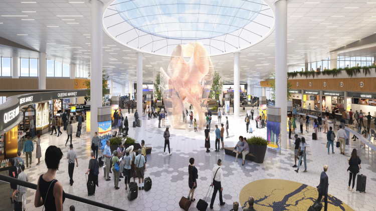 A shot of the East Hall Terminal 6, with art installation in the center and passengers walking around it 