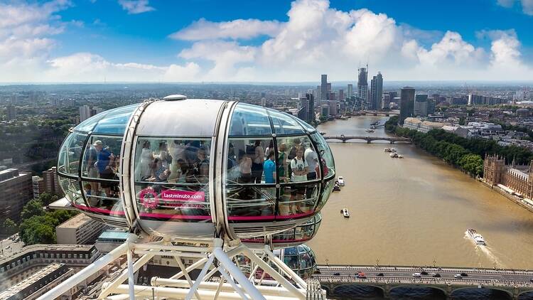 One of the London Eye's pods, filled with people looking out over the city. 