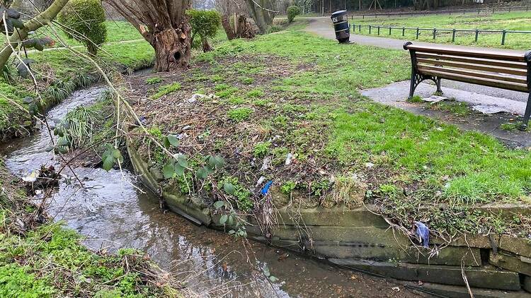 A section of Burnt Oak Brook running through a park. 