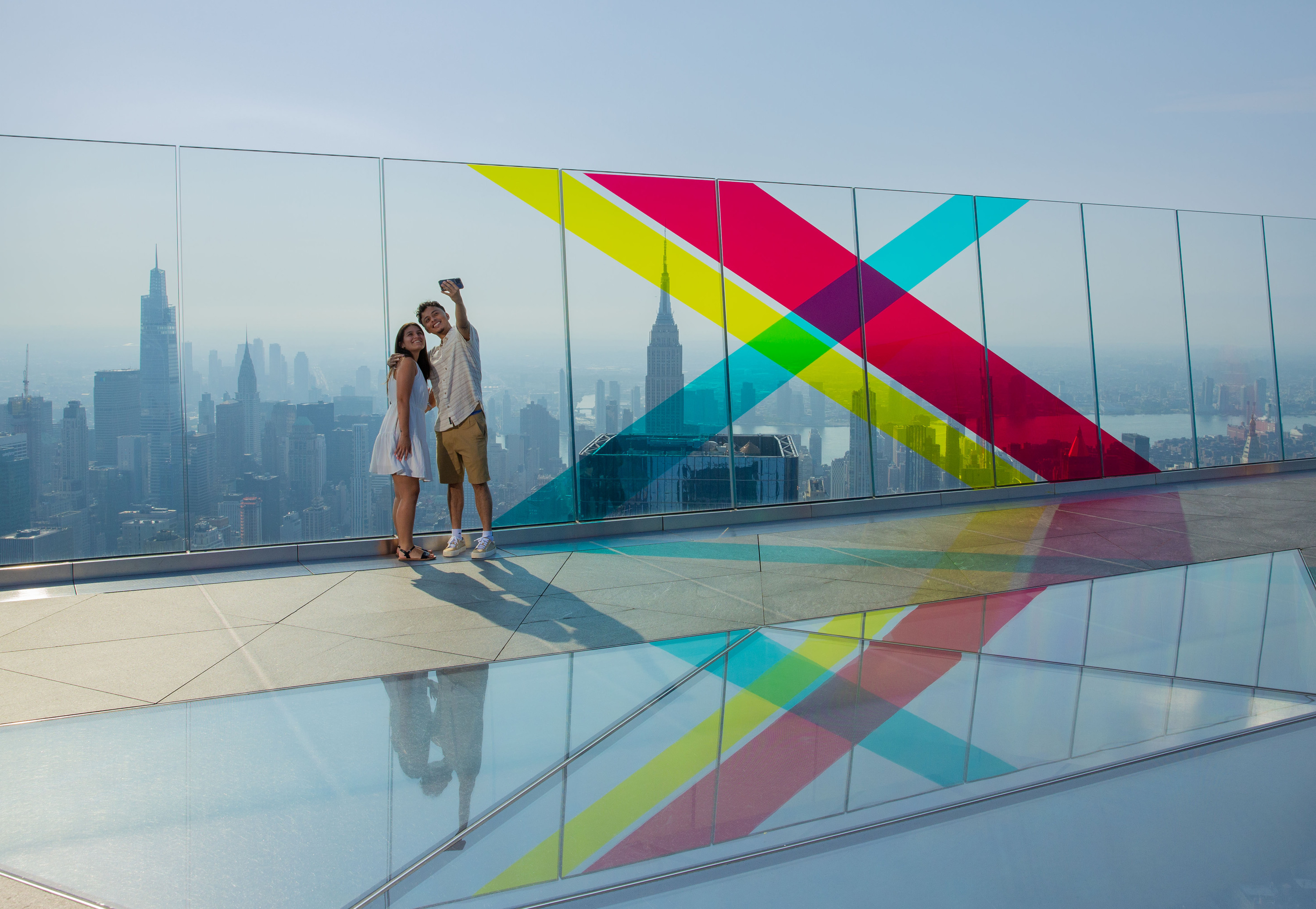 Two people pose on the skydeck at Edge. 