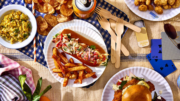 Overhead shot of food from Bankside by including the Lobster roll, crispy cod sandwich, brown butter corn and popcorn chicken                              