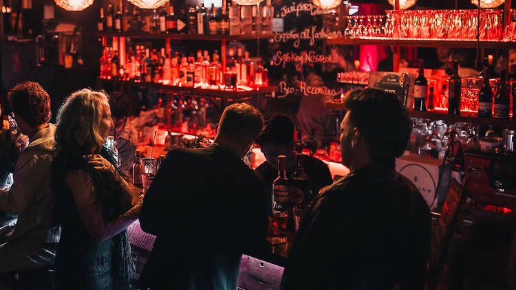 People stand around bar