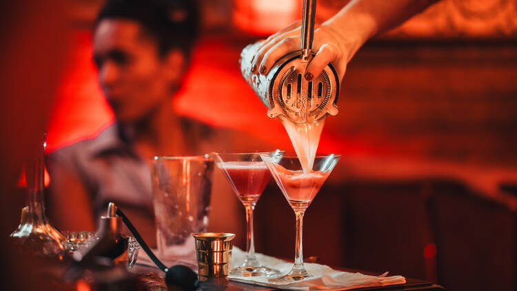 Bartender pours cocktails