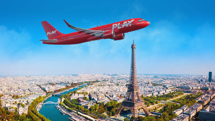 play airplane flying over eiffel tower