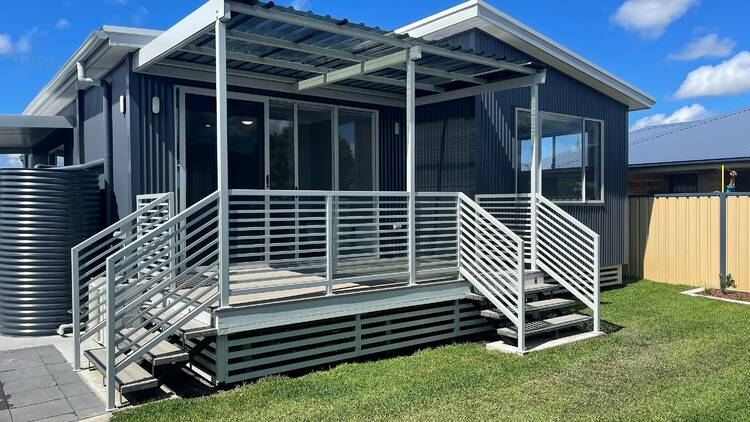  A modular home with a small grass lawn at the front