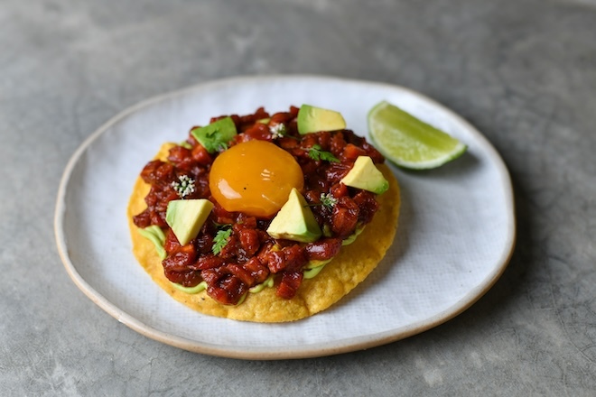 Beef tostada with pasilla salsa, cured eggs and avocado.