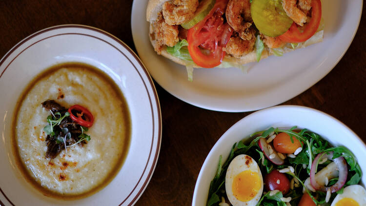 lamb and grits, po' boy, and salad 