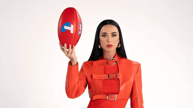 Katy Perry holding a football. 