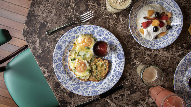 Kejriwal dish, with two eggs and chili toast on a blue and white plate sitting on a table