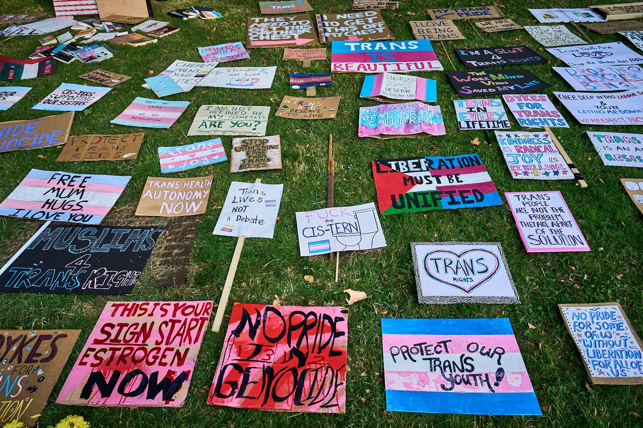 Trans pride placards on the ground 