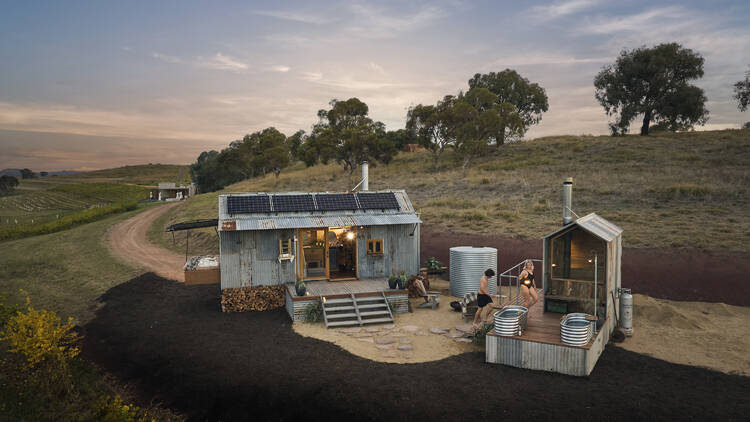 Two people staying at a pop-up accommodation in the countryside.