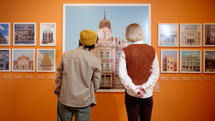 Two people look at Wes Anderson-inspired images