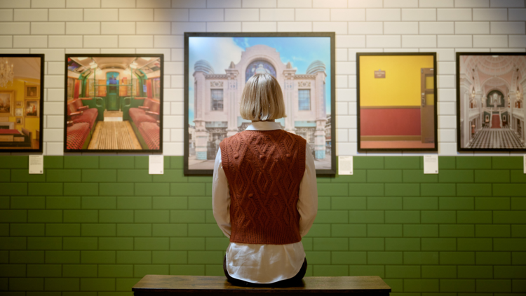 A person looks at Wes Anderson-inspired images