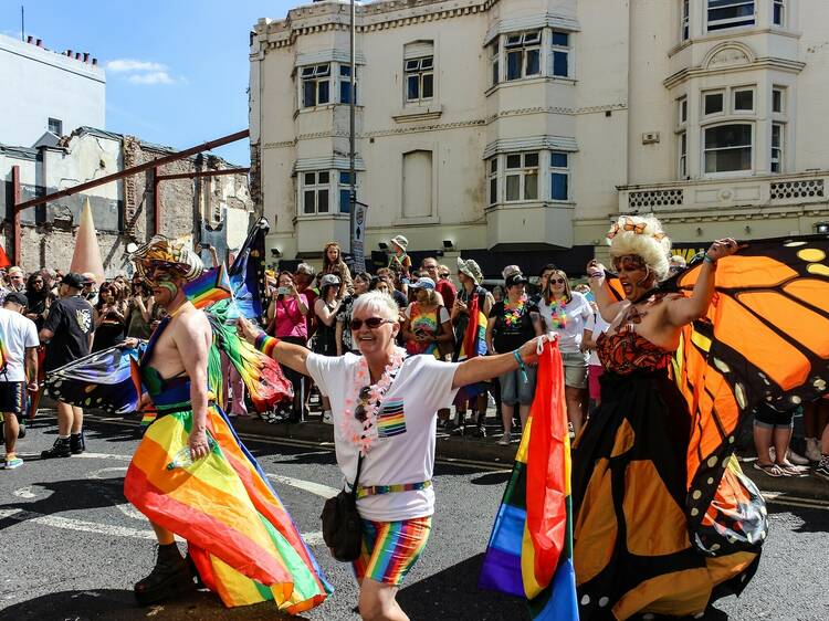 Brighton, United Kingdom - August 6, 2022: People marching with colorful costumes. Brighton Pride Parade.