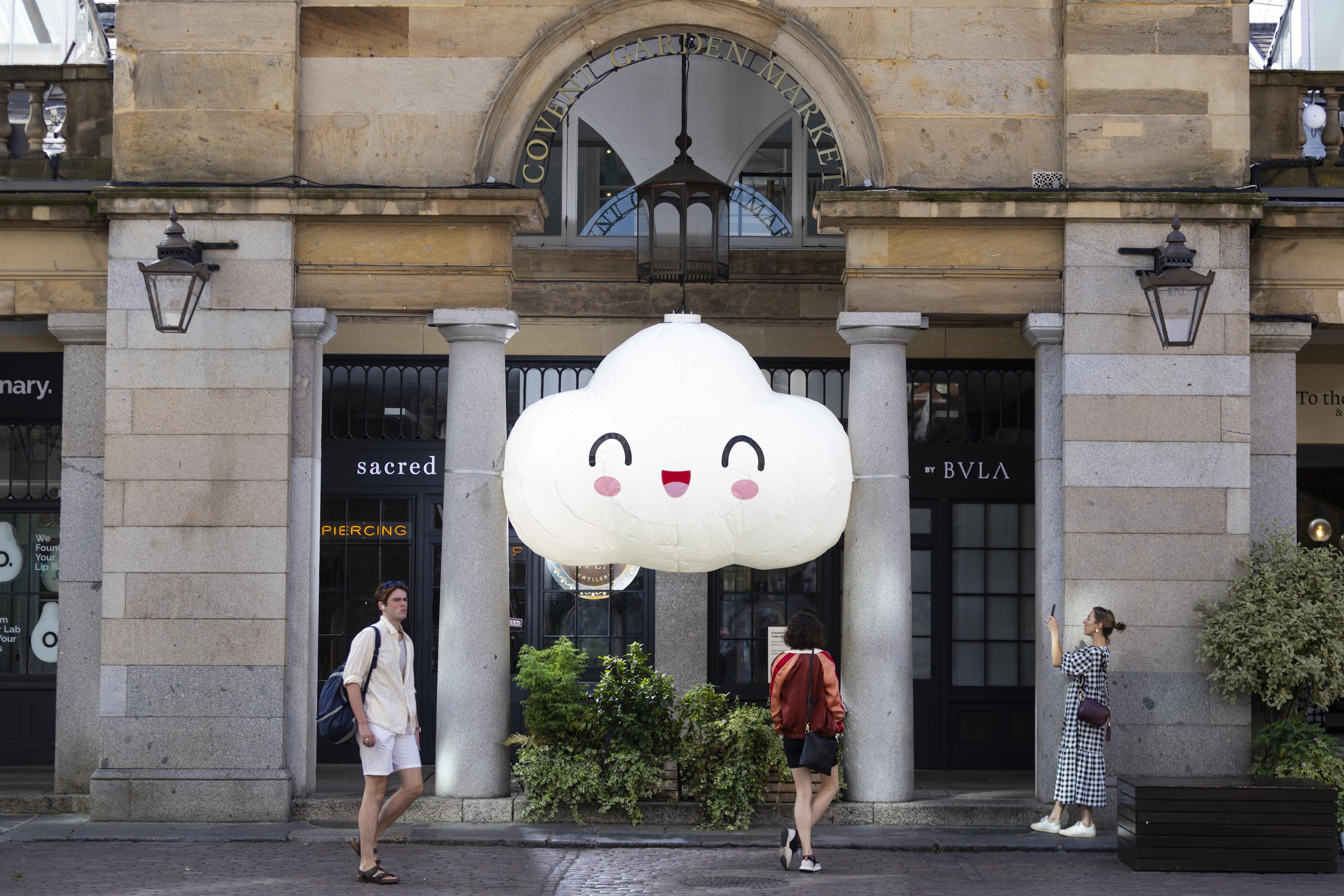 A large smiling cloud sculpture