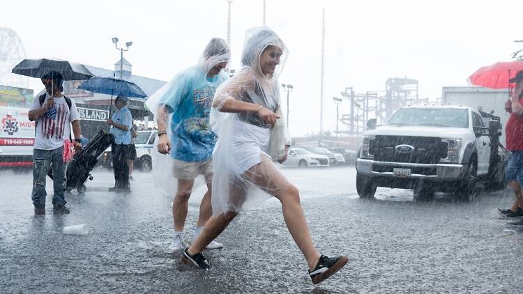 New Yorkers wading through rain puddles in Brooklyn