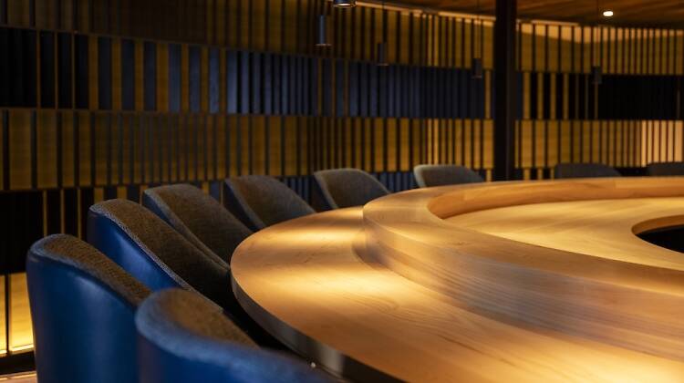 Leather seating around a wooden counter at Ikigai