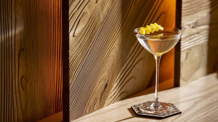 Martini sitting on a wooden bar at Ikigai