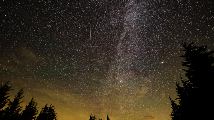 a meteor streaks across the sky