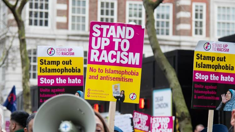 Anti-racist marchers in London with a 'Stand Up to Racism' placard