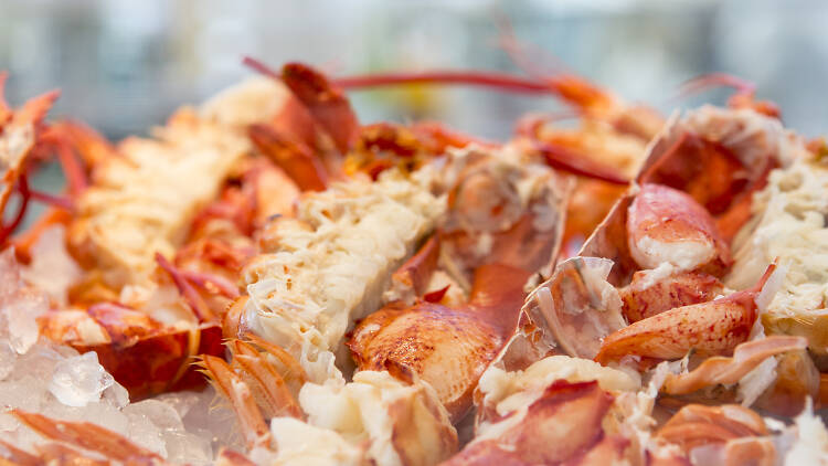 A tray of lobster sitting in a metal tray